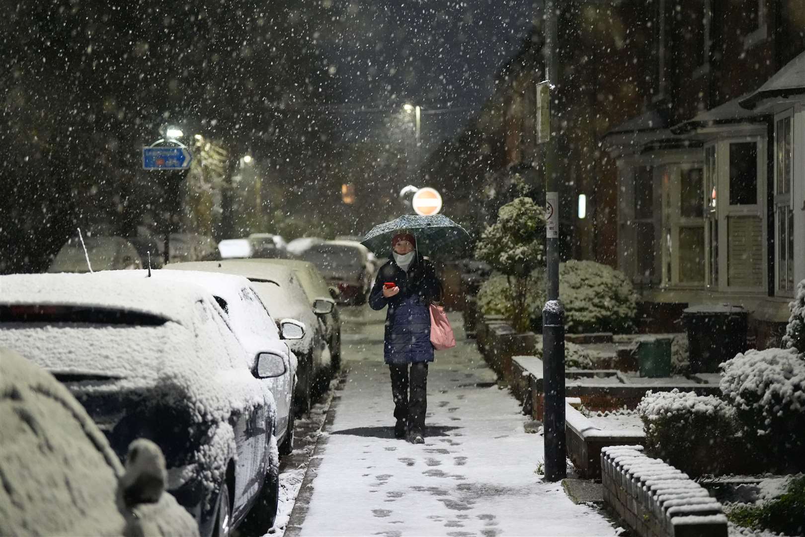 A person walks through snow in Warwick (Jacob King/PA)