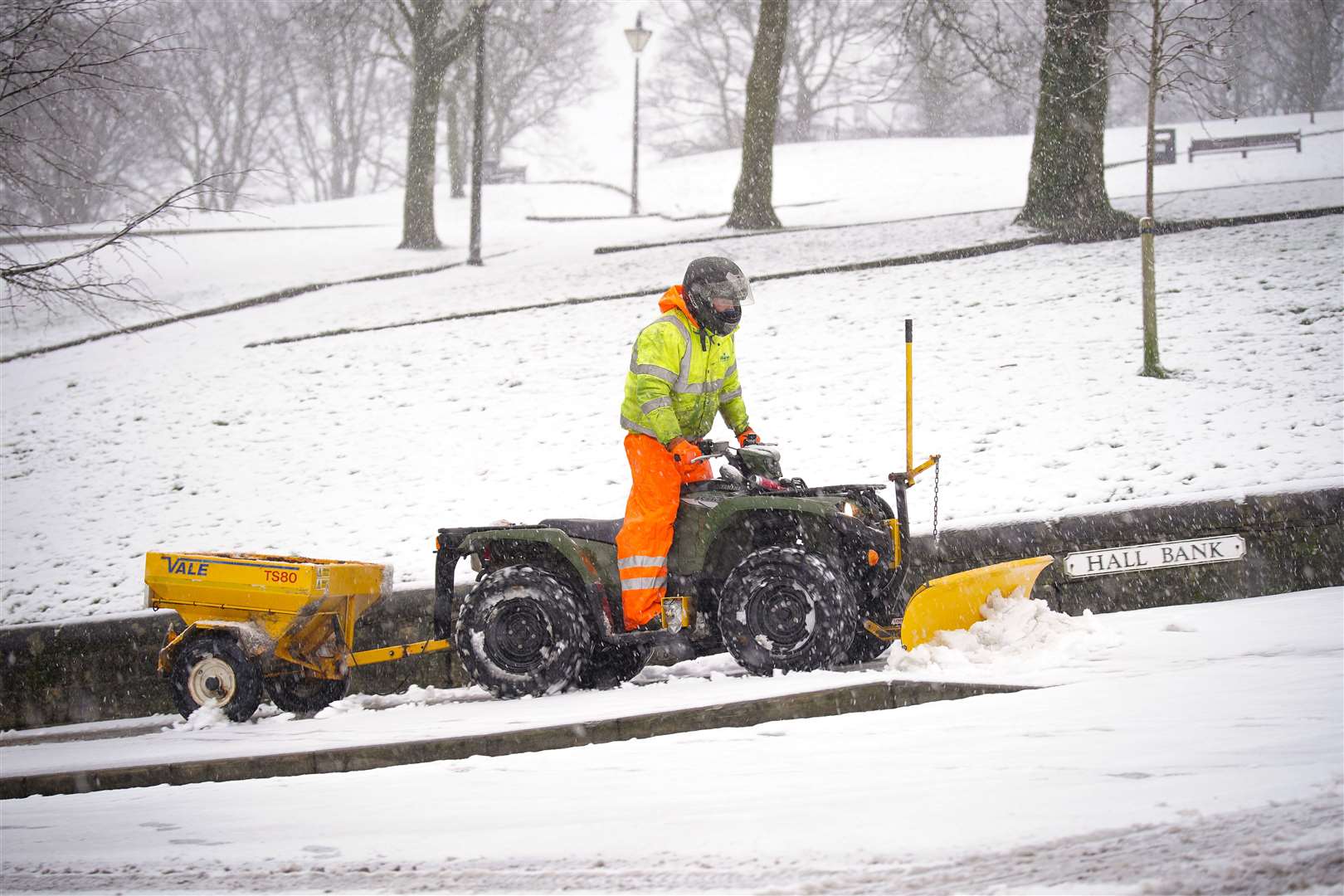 A snowplough clear a path at Hall Bank in Buxton in the Peak District (Peter Byrne/PA)