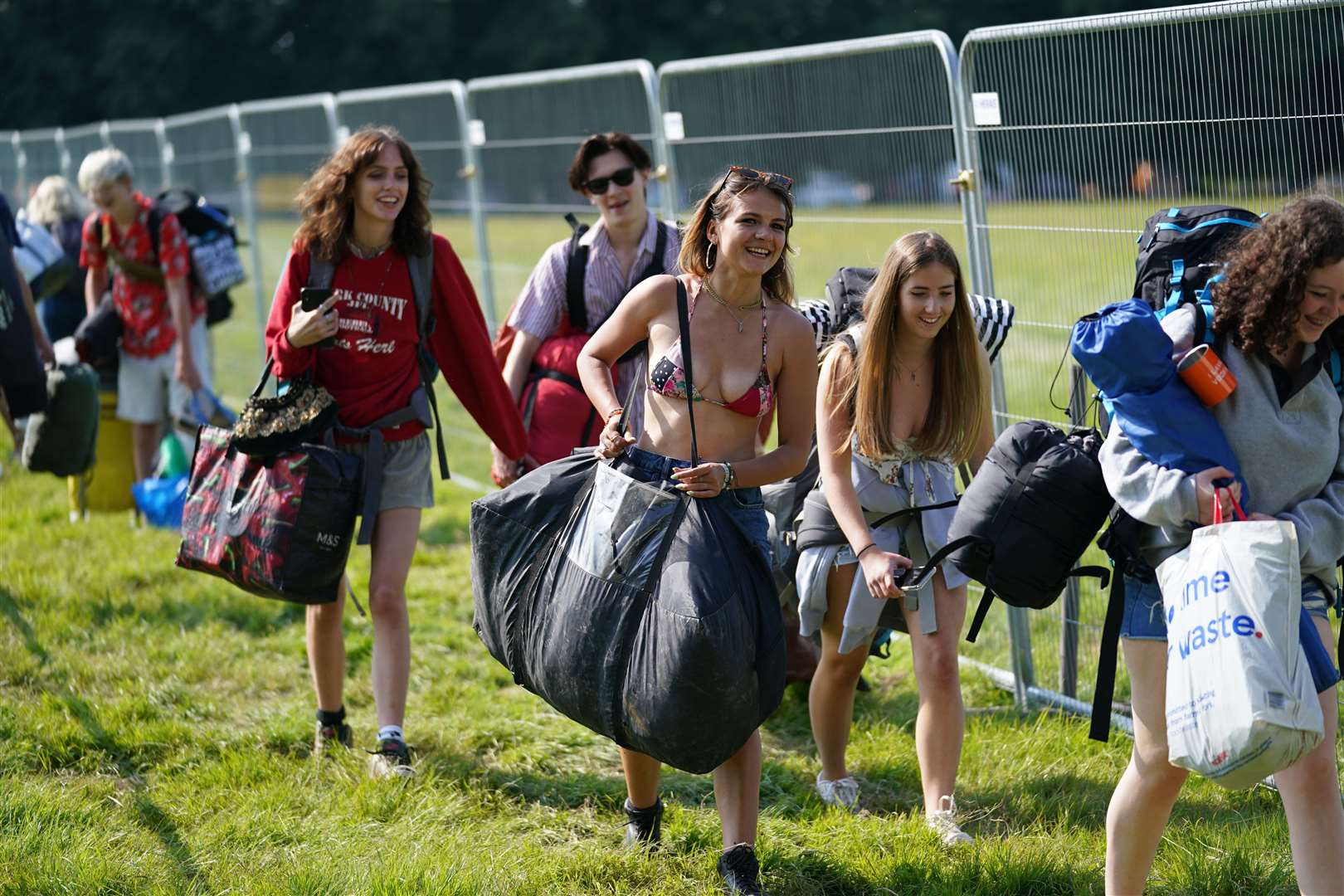 Festivalgoers arrive at the Latitude Festival in Henham Park, Suffolk, on Thursday (Jacob King/PA)