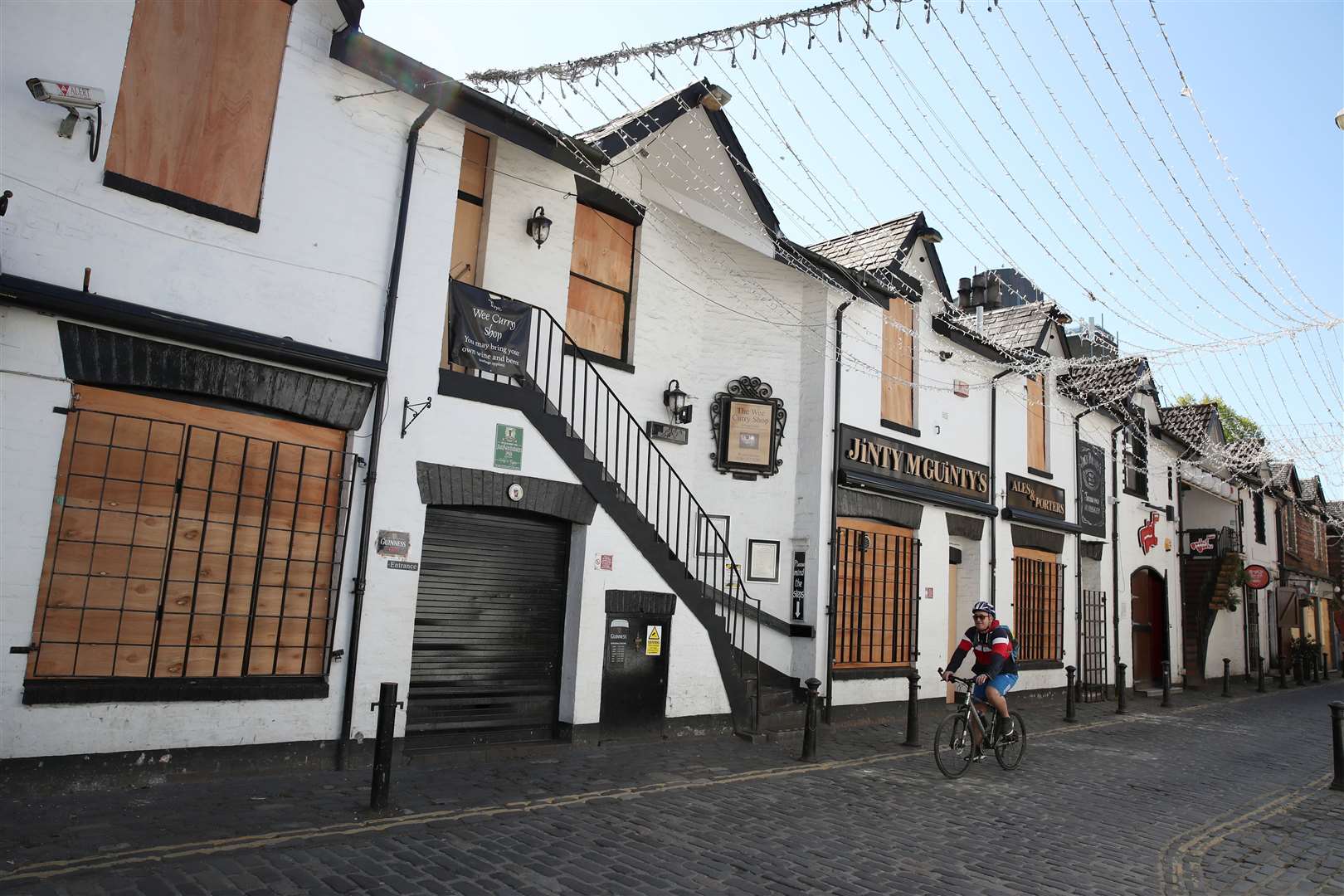 A view of boarded up restaurants and pubs in Glasgow (Andrew Milligan/PA)