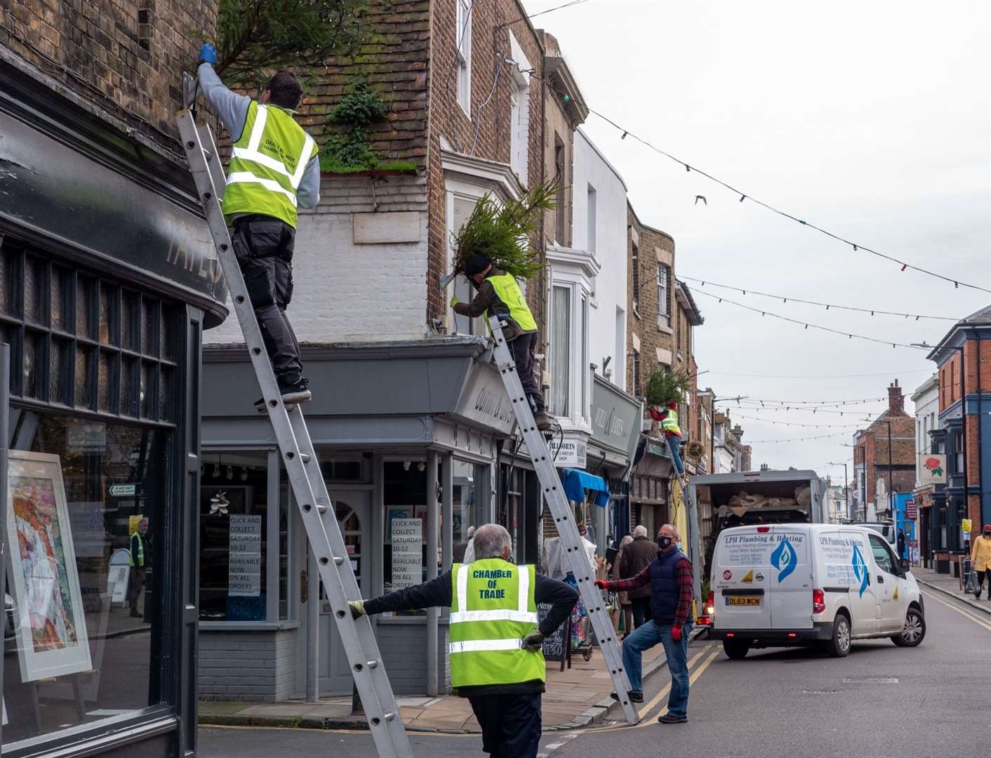 Volunteers from the Chamber and Deal Rowing Club erected free trees around the town Picture: Smugshot