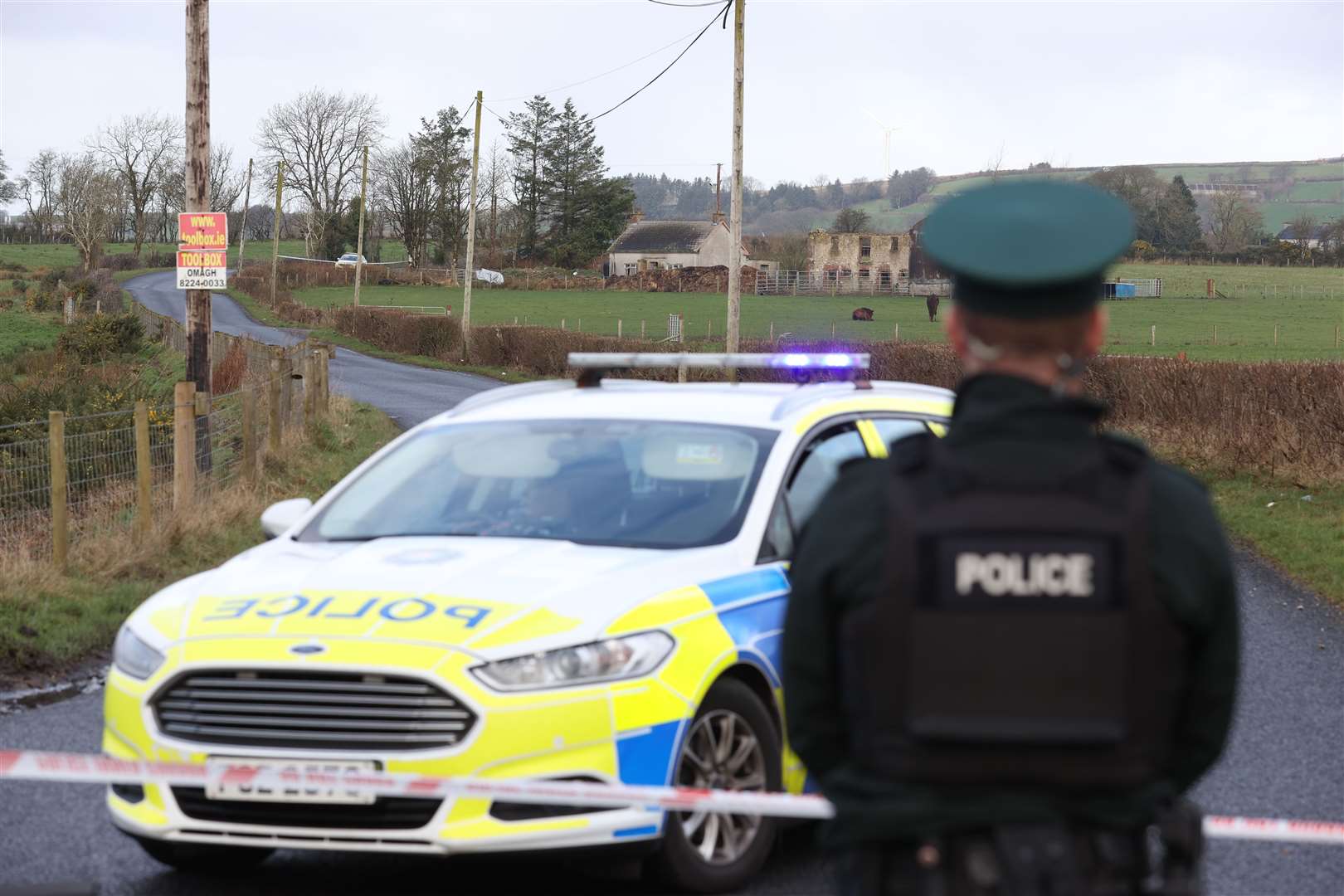 A police cordon near a property on Racolpa Road in Drumnakilly, where a vehicle was burnt out overnight (Liam McBurney/PA)