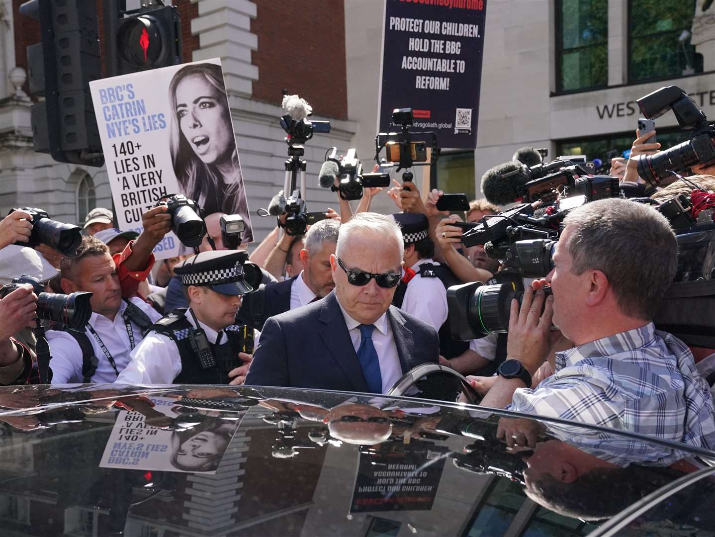 Huw Edwards surrounded by journalists and photographers when leaving court (Jonathan Brady/PA)