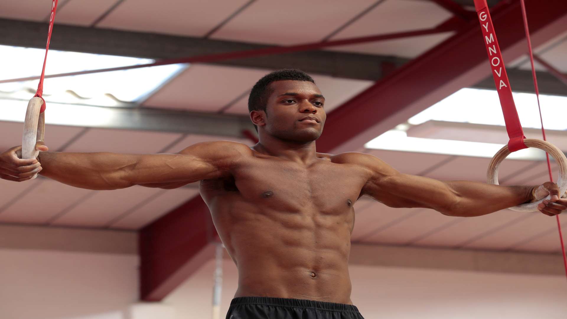 Courtney Tulloch shows his strength on rings Picture: Martin Apps