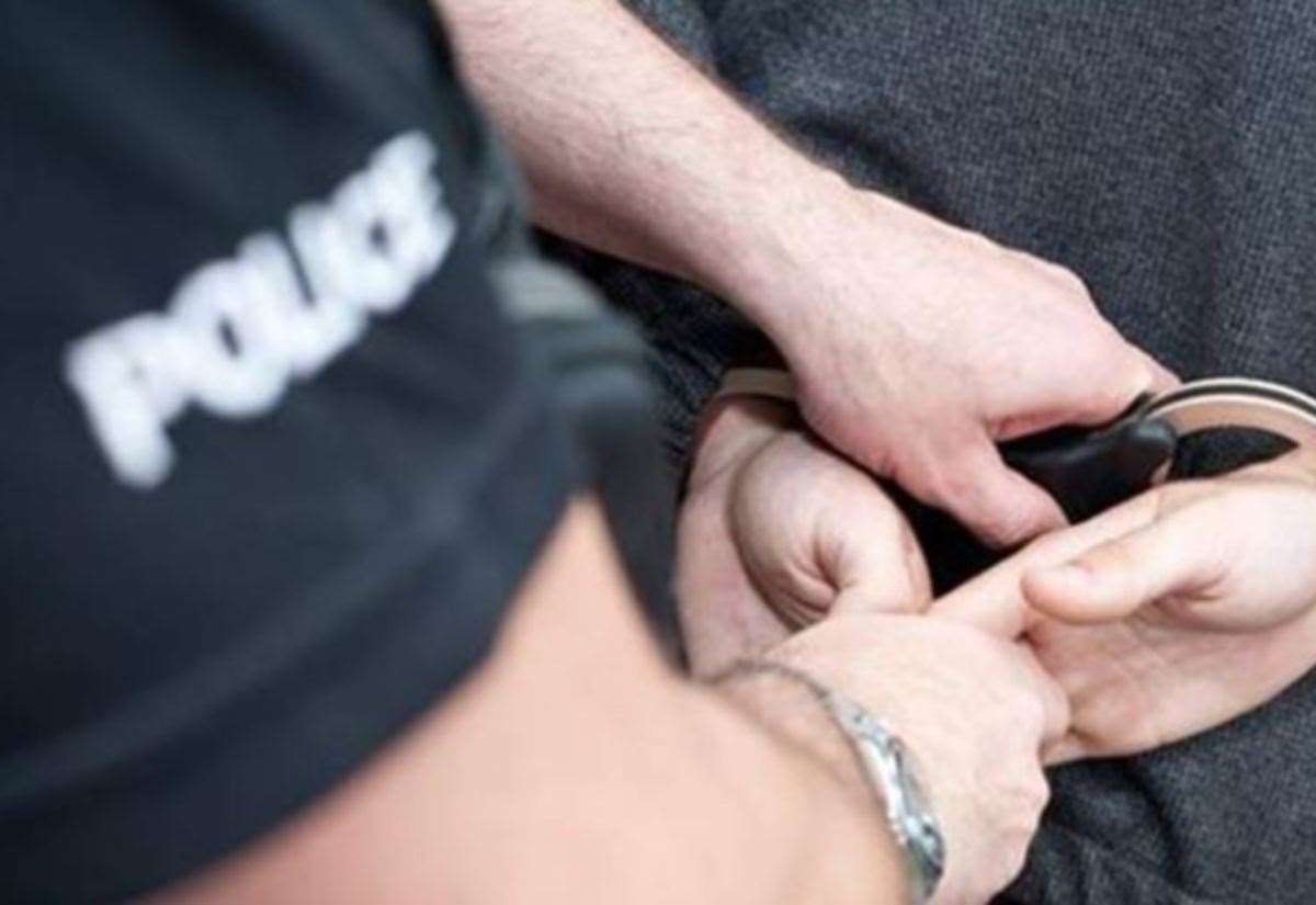 A police officer making an arrest - stock image