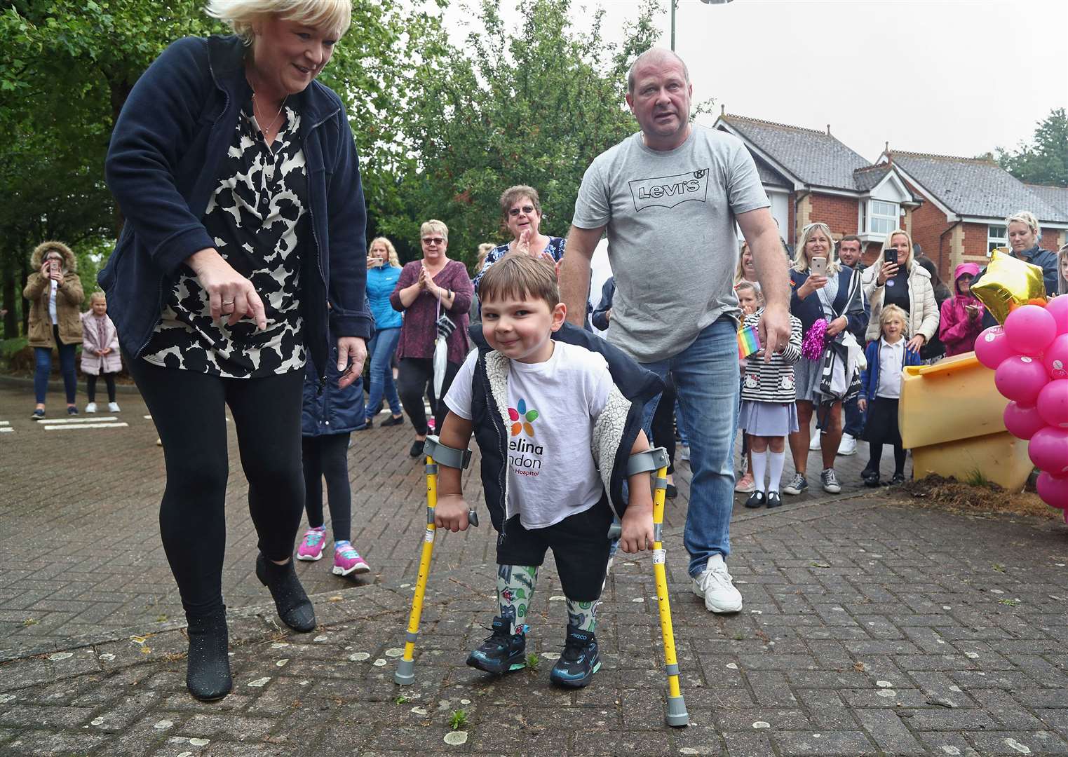 Sir Tom inspired fundraisers young and old – including five-year-old Tony Hudgell, who walked 10km over 30 days on his prosthetic legs to raise £1 million for the hospital that cared for him (Gareth Fuller/PA)