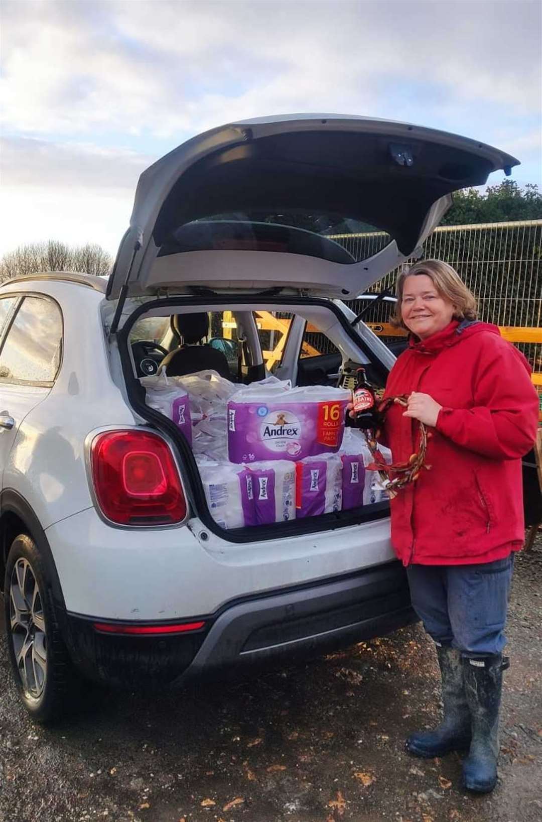 Prize winner Julie Roe with a year’s supply of loo roll, a box of Goody Ales and dog biscuit wreaths