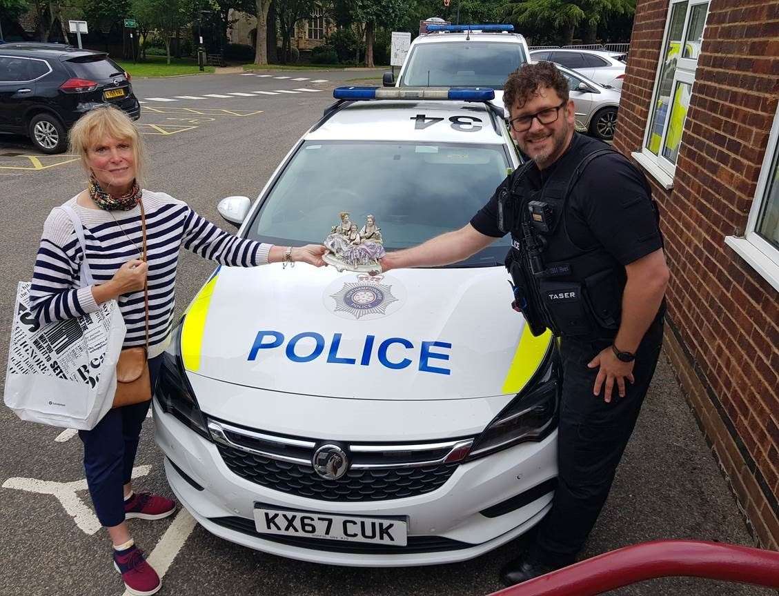 Catherine Merry receiving the stolen ornament from PC Tamlin Rees (Northamptonshire Police /PA)