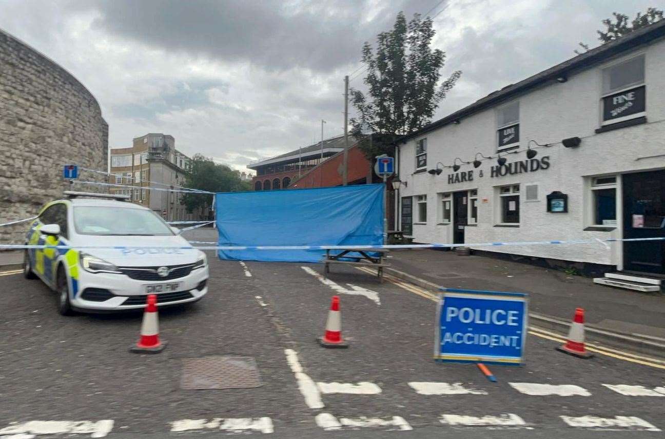 Police outside the Hare and Hounds pub the following day