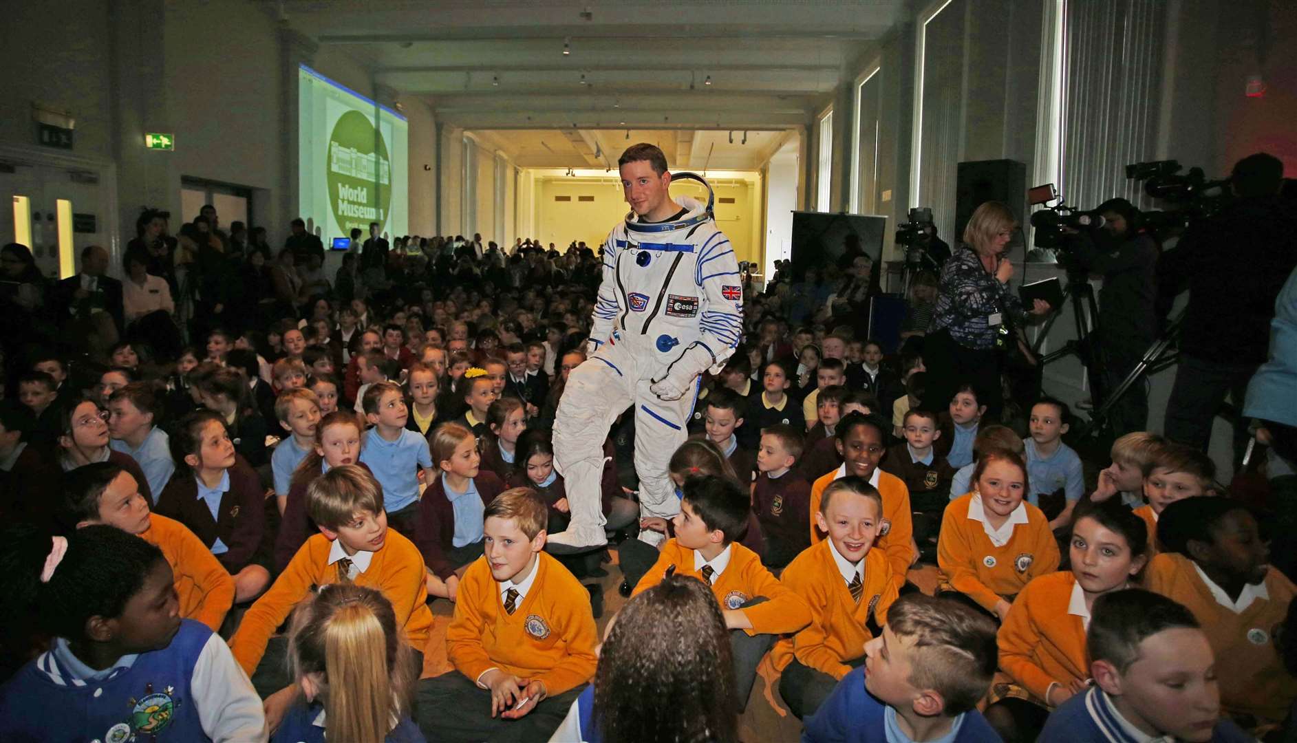 A man in a space suit with children at Liverpools World Museum (Peter Byrne/PA)