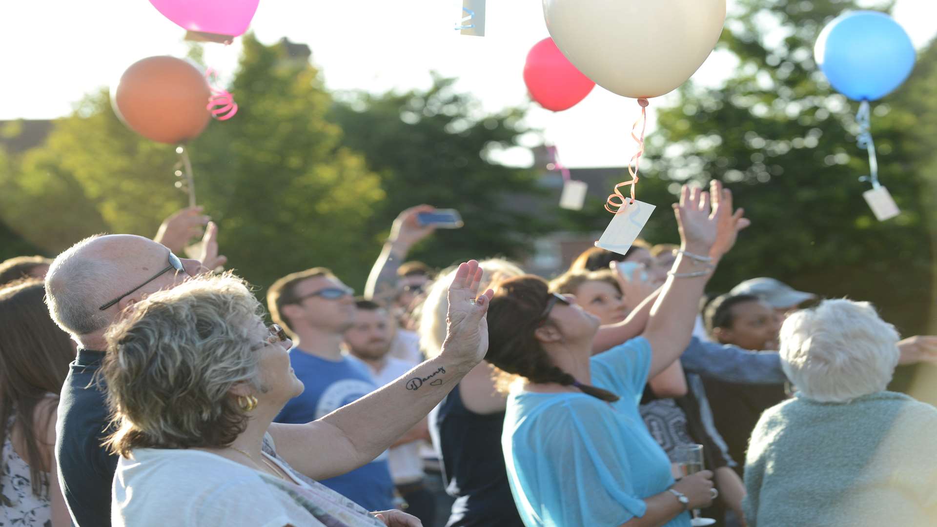 Family and friends attached messages to the balloons for Danny Hall, before releasing them