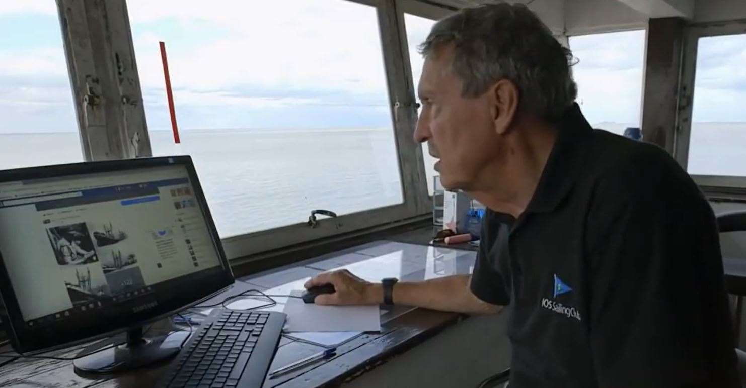 Wreck-watcher Tim Bell in the control tower of the Isle of Sheppey Sailing Cub checking the masts of the Sheppey bomb ship the SS Richard Montgomery. Picture: NDR