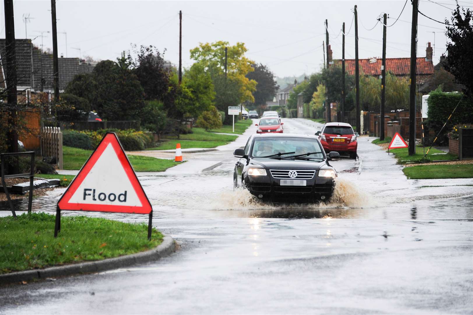 A vehicle makes its way through heavy flooding