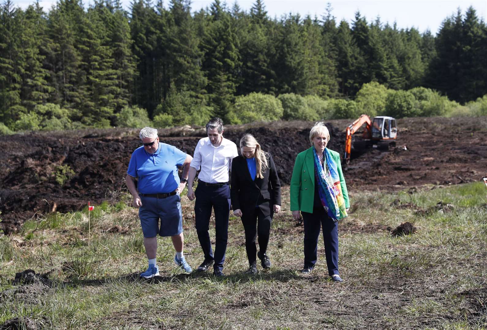 Simon Harris, Senator Emer Currie and Minister for Social Protection Heather Humphreys talk with Oliver McVeigh (left), the brother of Columba McVeigh, during a visit to the remote Bragan Bog in Co Monaghan (Peter Morrison/PA)