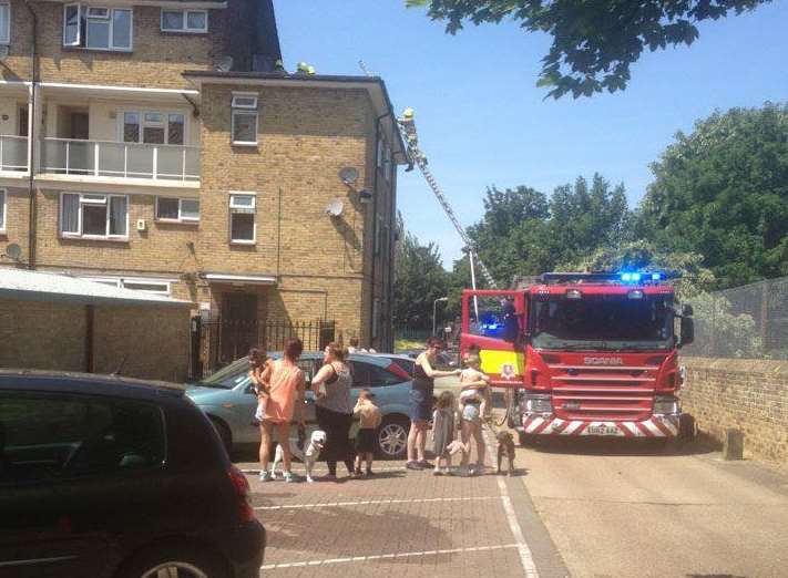 Crowds gathered as firefighters climbed the roof of a neighbouring property to extinguish the blaze. Picture: Christine Connal / Gravesend News