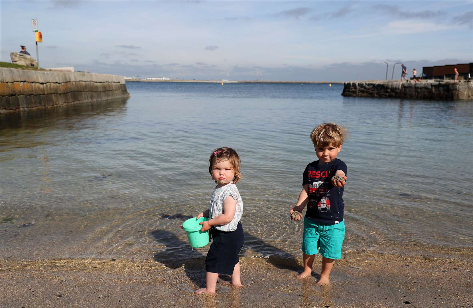 Matilda Thomas, two, and her brother Fredrik, three, paddling at Sandycove Beach, Dublin (Brian Lawless/PA)