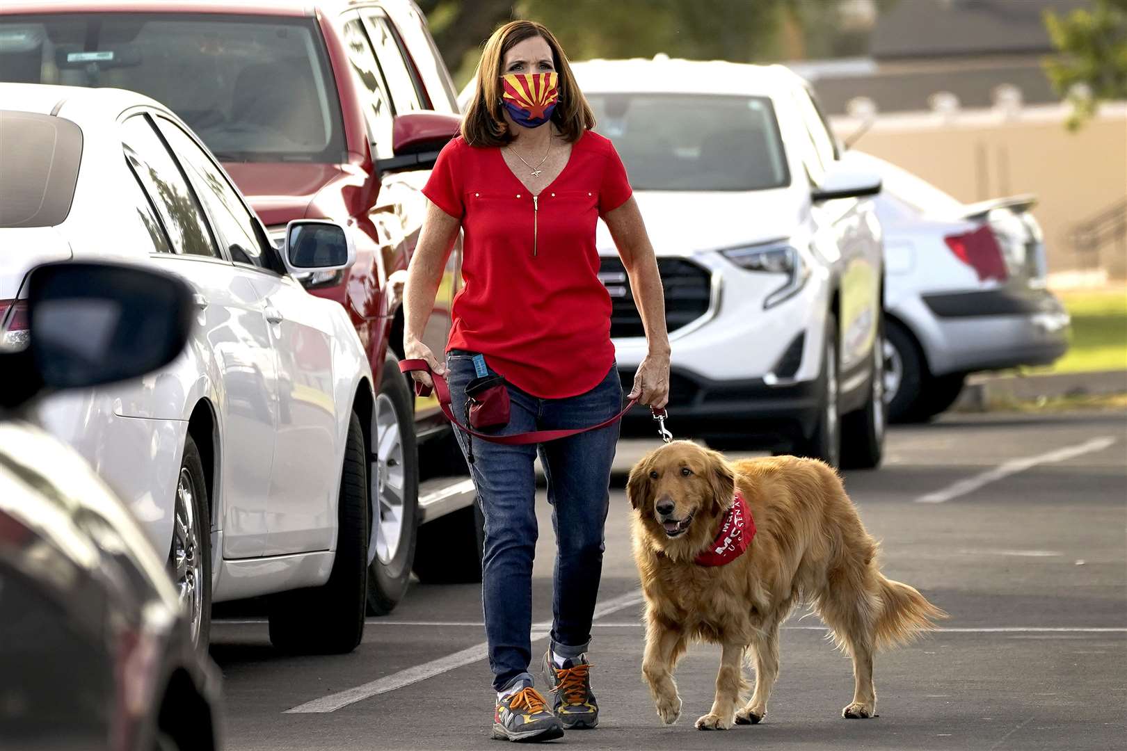 U.S. Senator Martha McSally walks her dog Boomer to greet voters at a polling station in Arizona (AP Photo/Matt York)