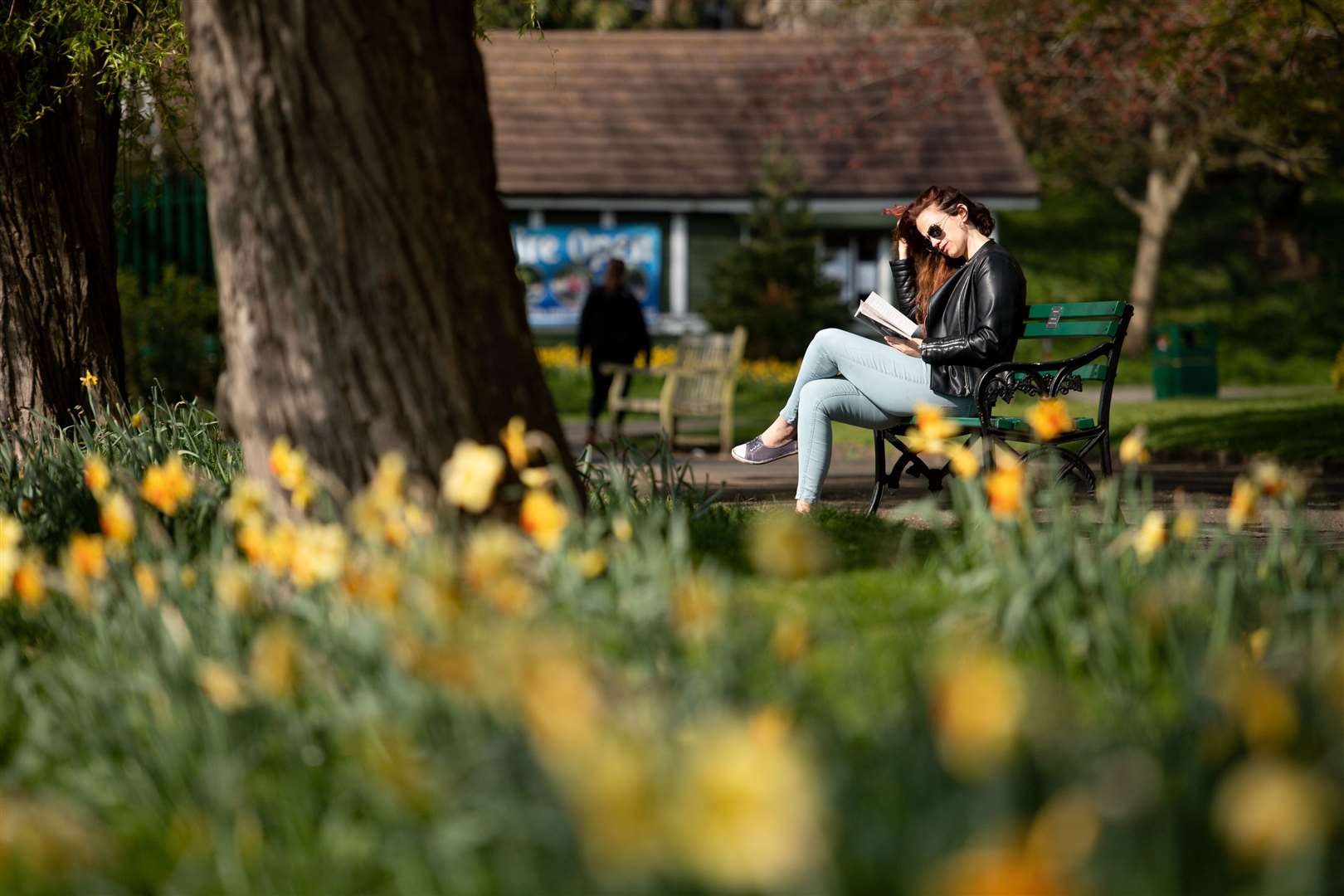 A woman reads in St Nicholas’ Park (Jacob King/PA)