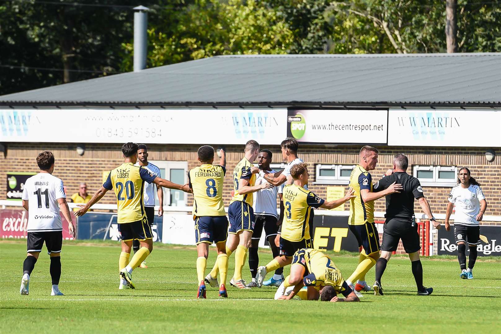 Dover's Kurtis Cumberbatch exchanges words with the Woking players before being sent off at Crabble. Picture: Alan Langley