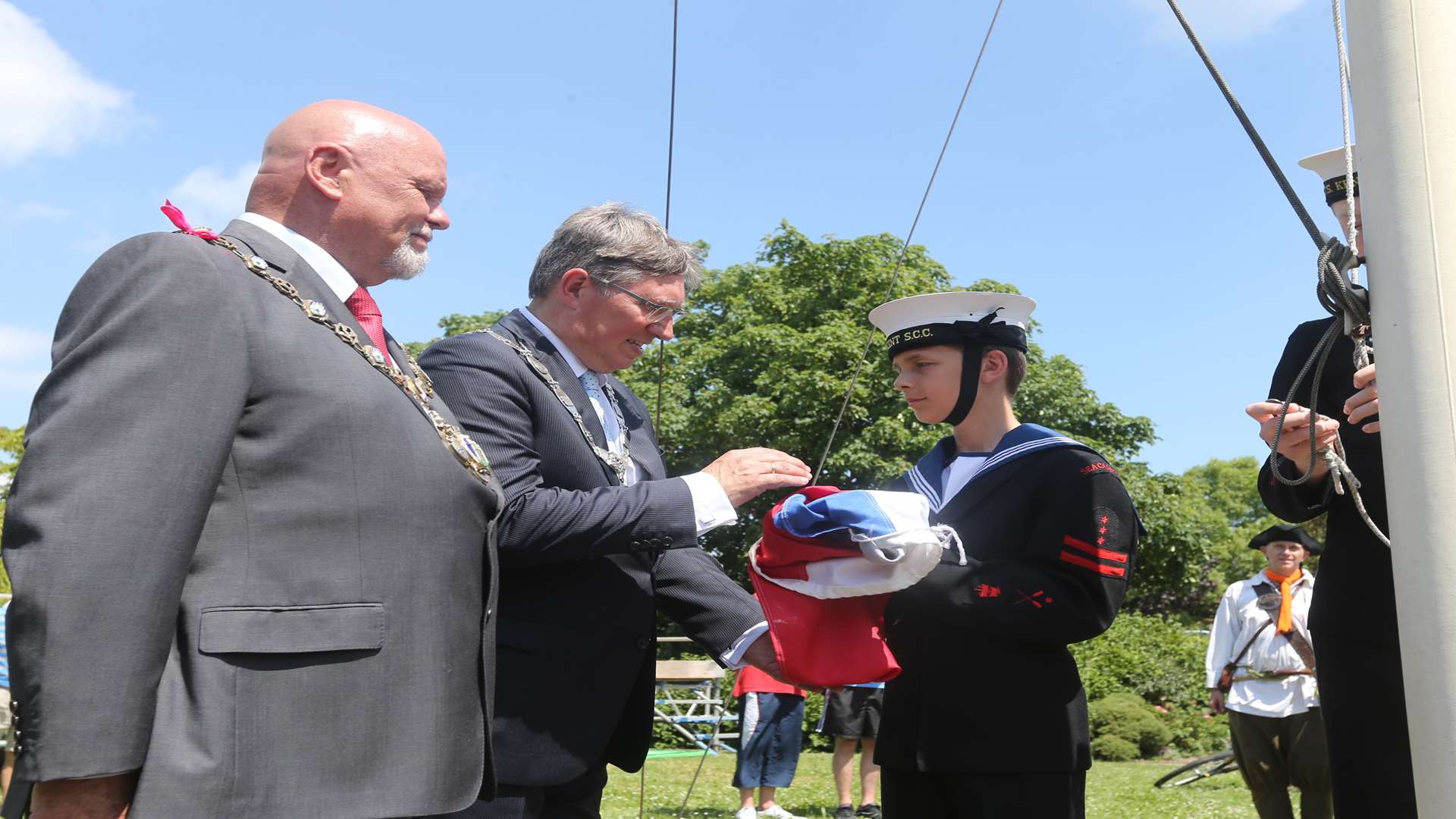 Mayor of Queenborough Cllr Mick Constable, left, with Gregor Rensen, Mayor of Brielle, receives the Dutch flag from Sheppey Sea Cadets in an exchange for the Union flag at the 50th anniversary of the official handing back of Queenborough by the Dutch.
