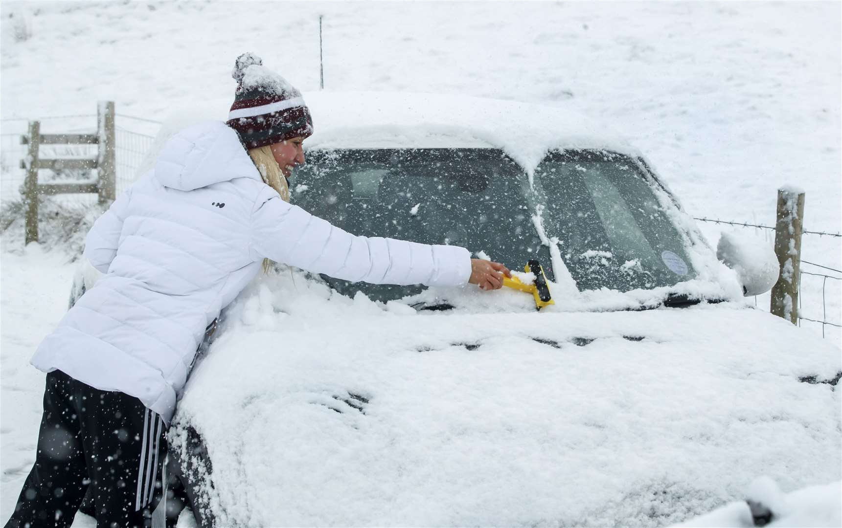 You should clear snow and ice from your car’s windows and body before setting off (Danny Lawson/PA)