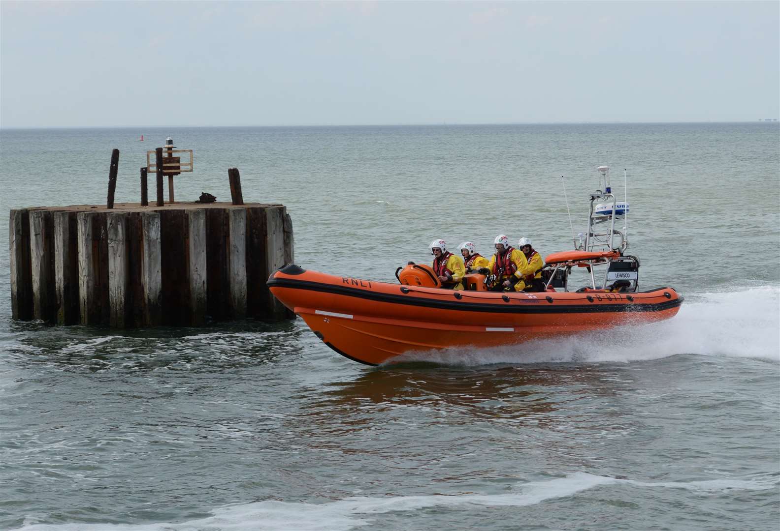 Whitstable lifeboat passing the mooring structure known as a Dolphin. Stock picture by Chris Davey