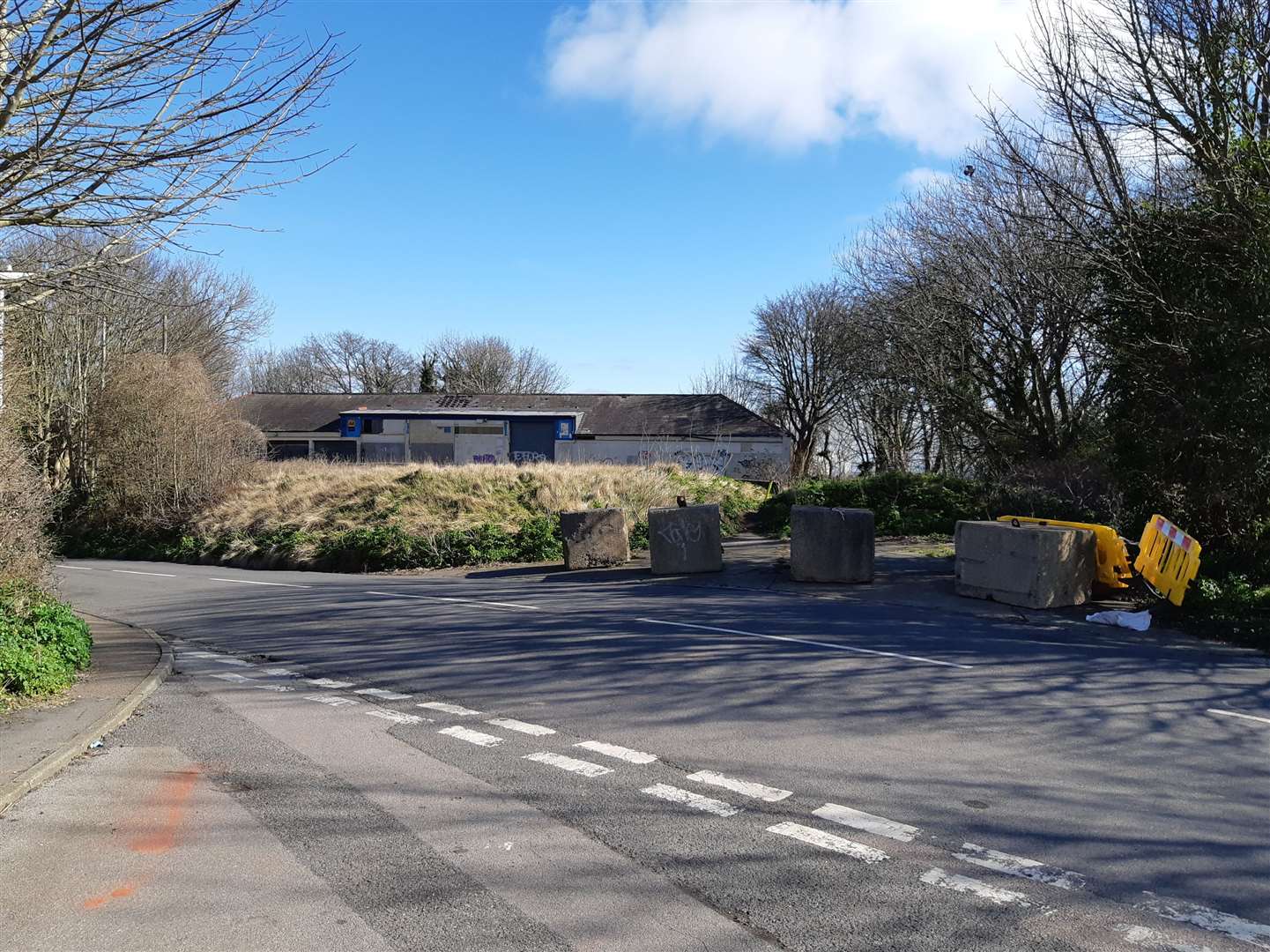 The scene today: Police search teams have left the BCB garage and Military Road area