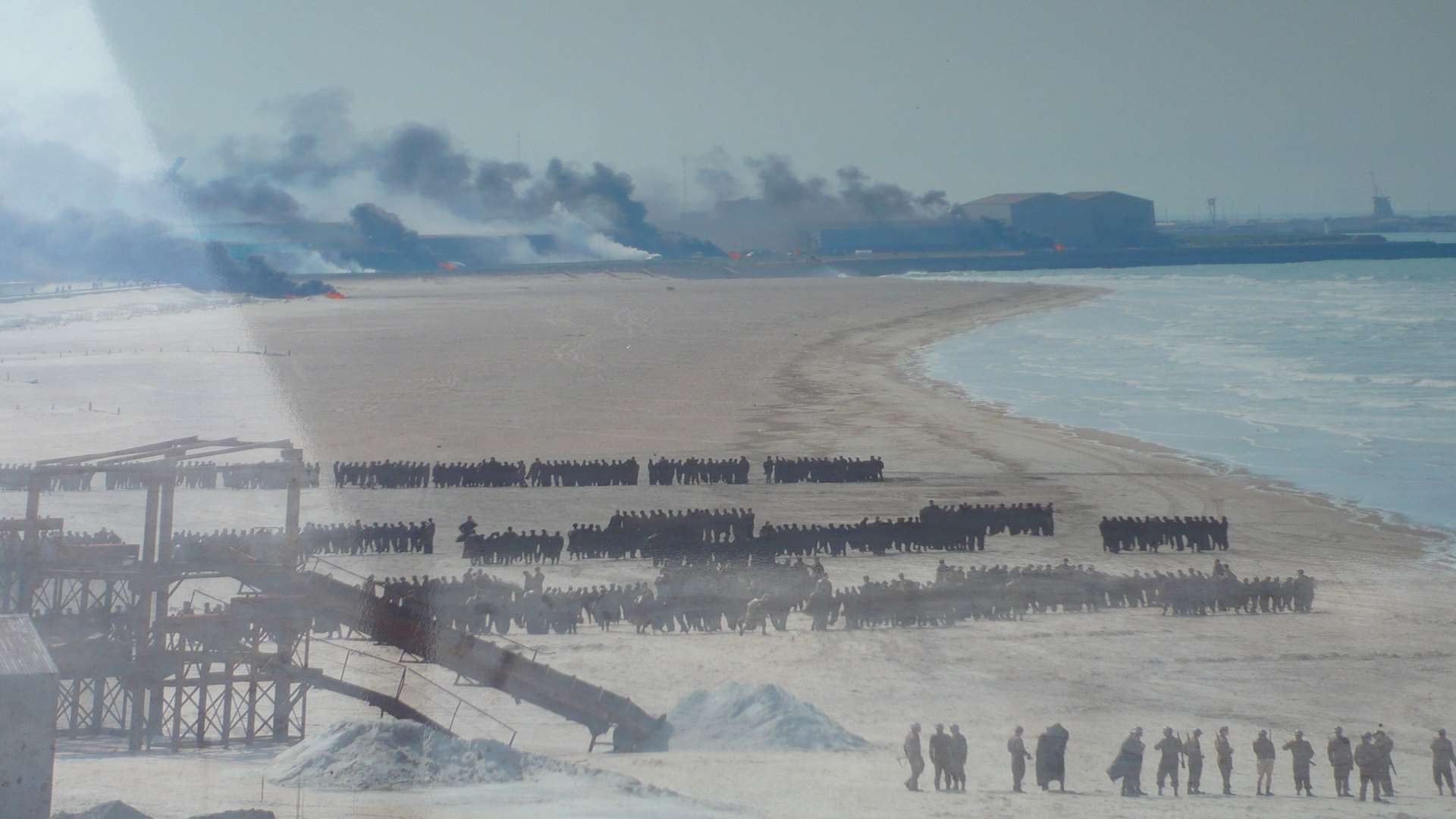 Dunkirk beach was transformed with thousands of extras and factories were made to look on fire for the film.