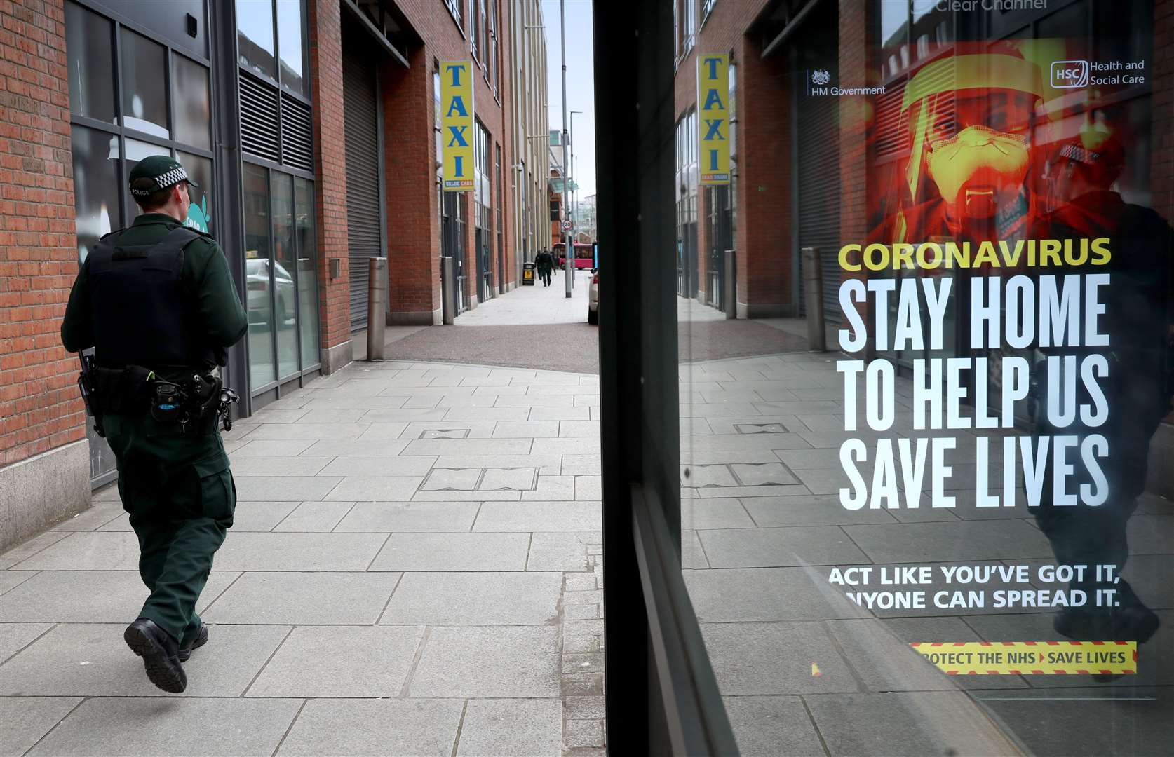 A PSNI officer on patrol in Belfast city centre during the coronavirus pandemic restriction period (PSNI/PA)