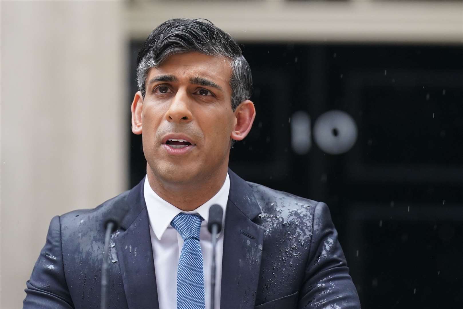 Rishi Sunak chose to announce the general election outside Downing Street with no umbrella despite the rain (Stefan Rousseau/PA)