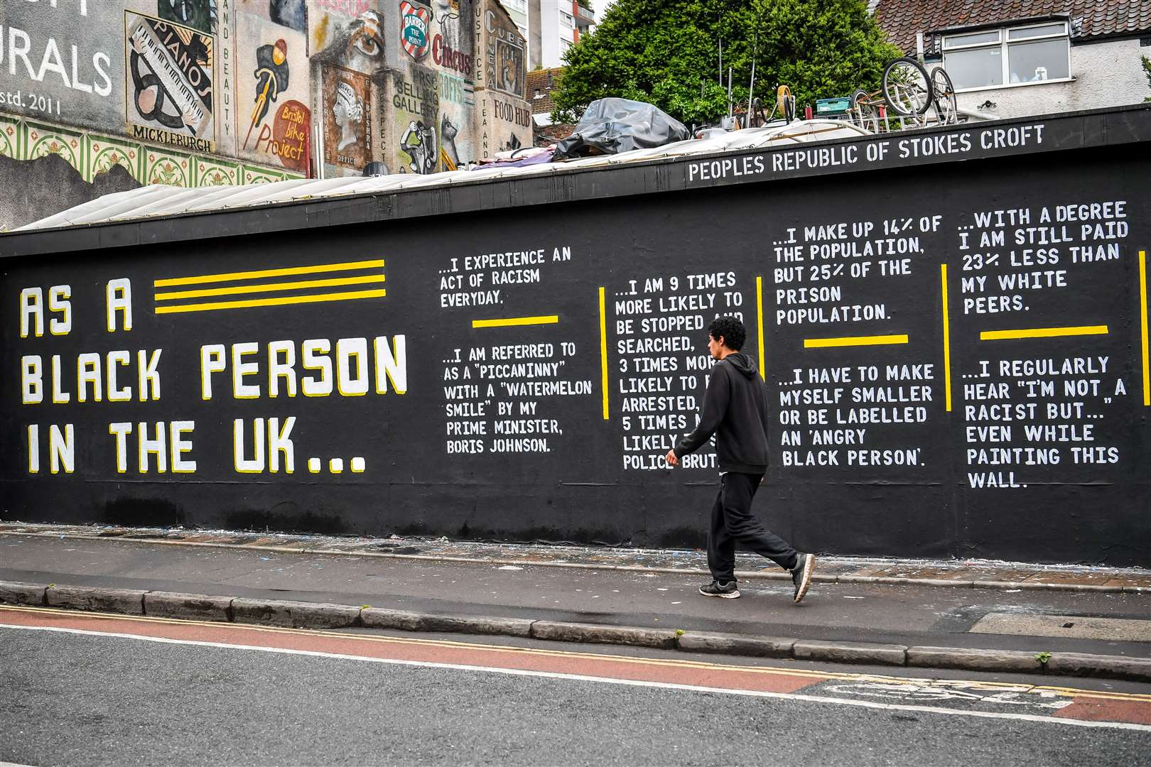 A man walks past a graffiti art piece on Black Lives Matter on a wall in the Stokes Croft area of Bristol following a raft of Black Lives Matter protests (Ben Birchall/PA)