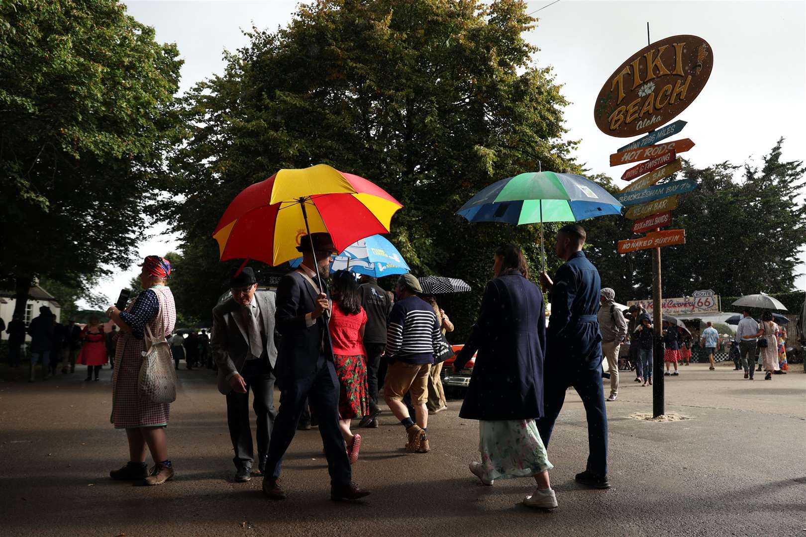 Race meet goers in the rain (Kieran Cleeves/PA)