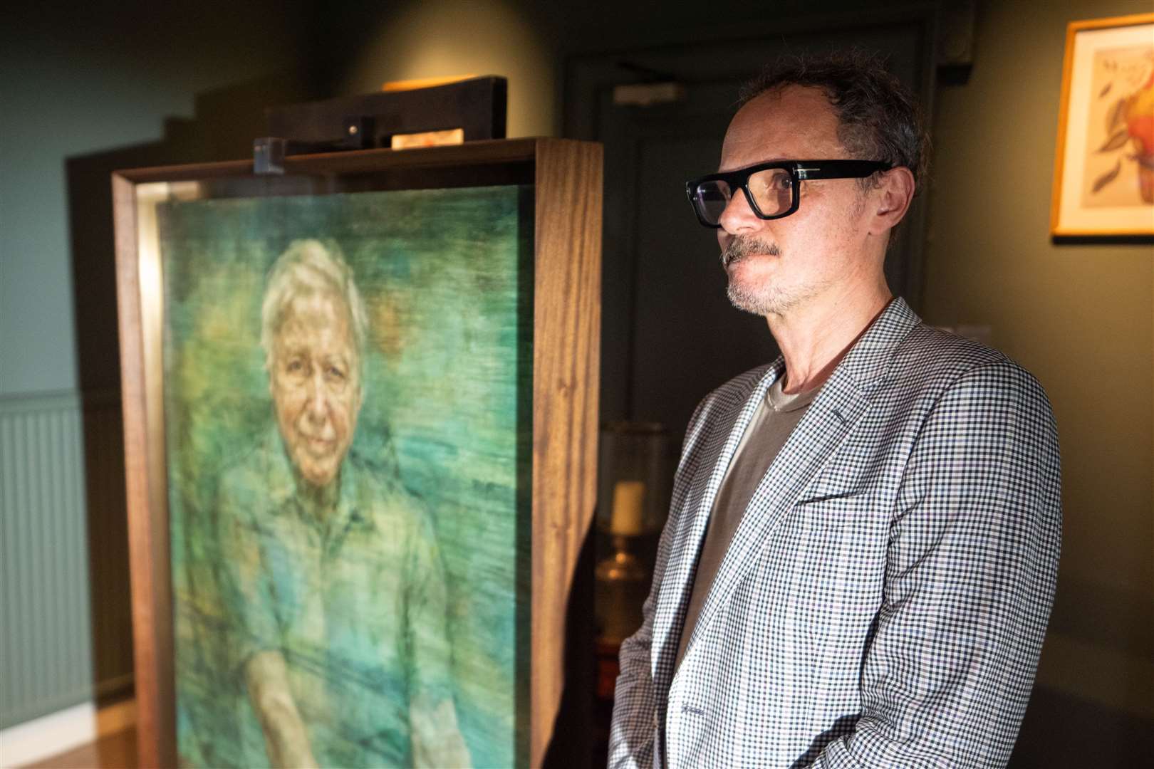 Artist Jonathan Yeo with his portrait of Sir David Attenborough at a private ceremony at the Royal Society in London (James Manning/PA)