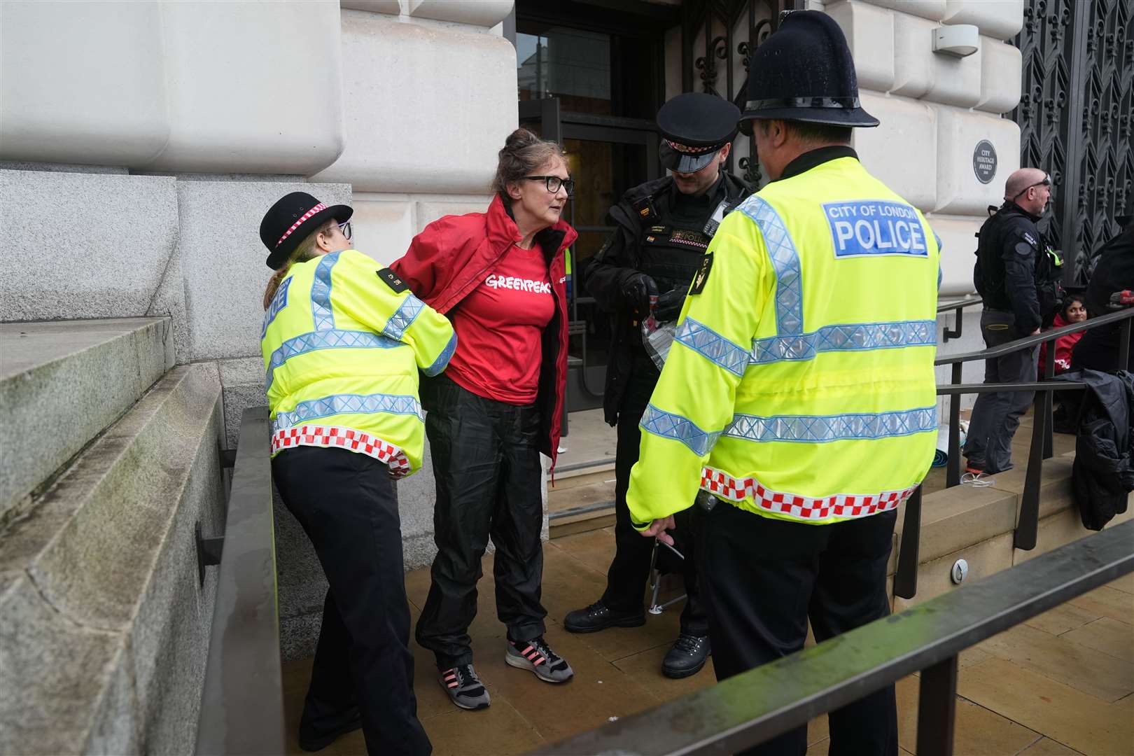 Police remove activists outside Unilever’s headquarters (Lucy North/PA)