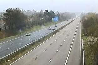 View of the scene where a car and trailer slid down embankment on M20 at Ashford