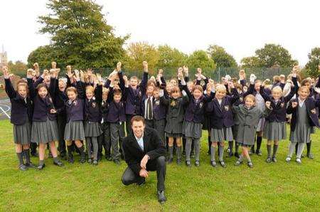 The children of St Faith's School, Ash, celebrate after the opening of their new tarmac play area by Geraint Jones