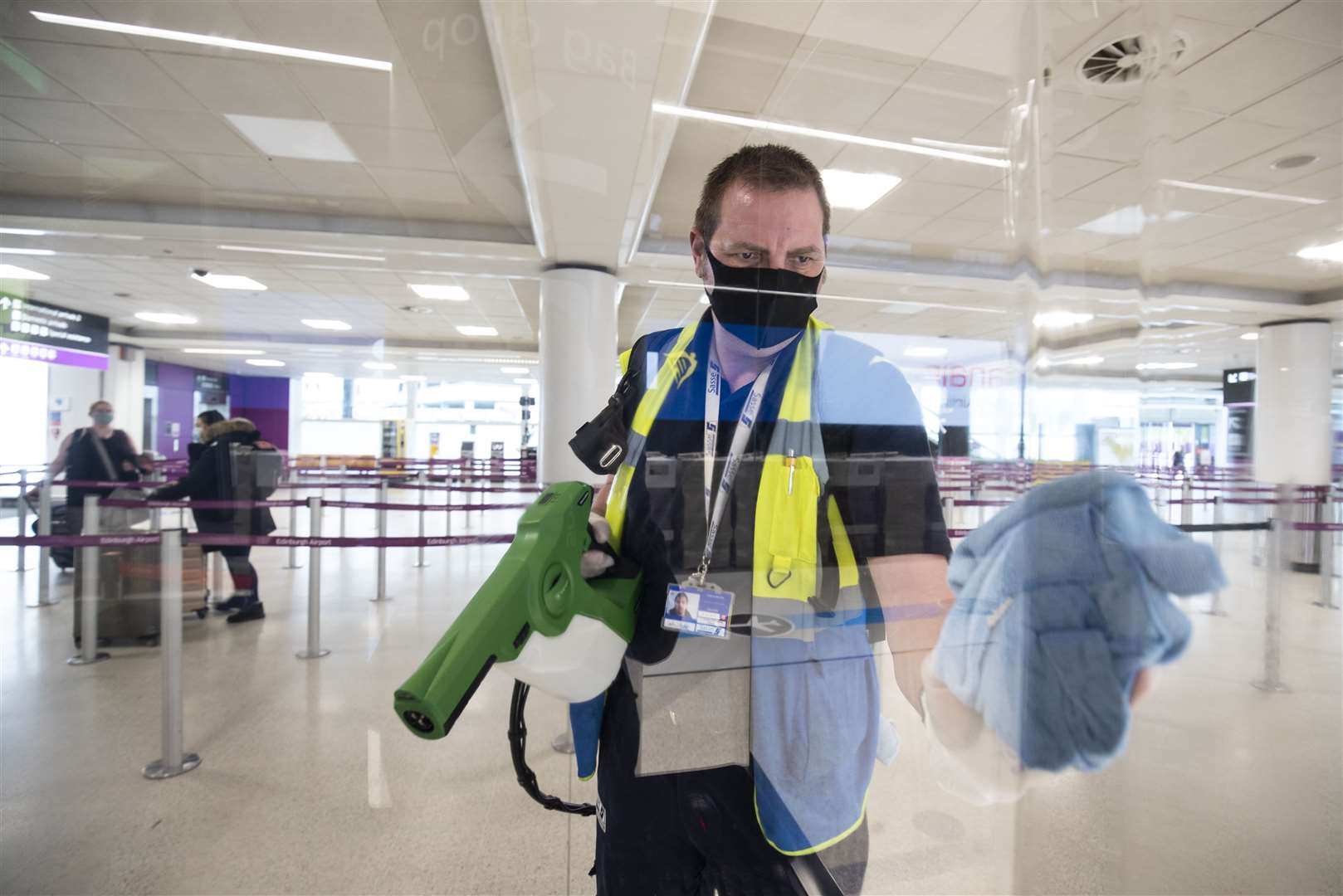 Screens at check-in desks at Edinburgh Airport are disinfected (Jane Barlow/PA)