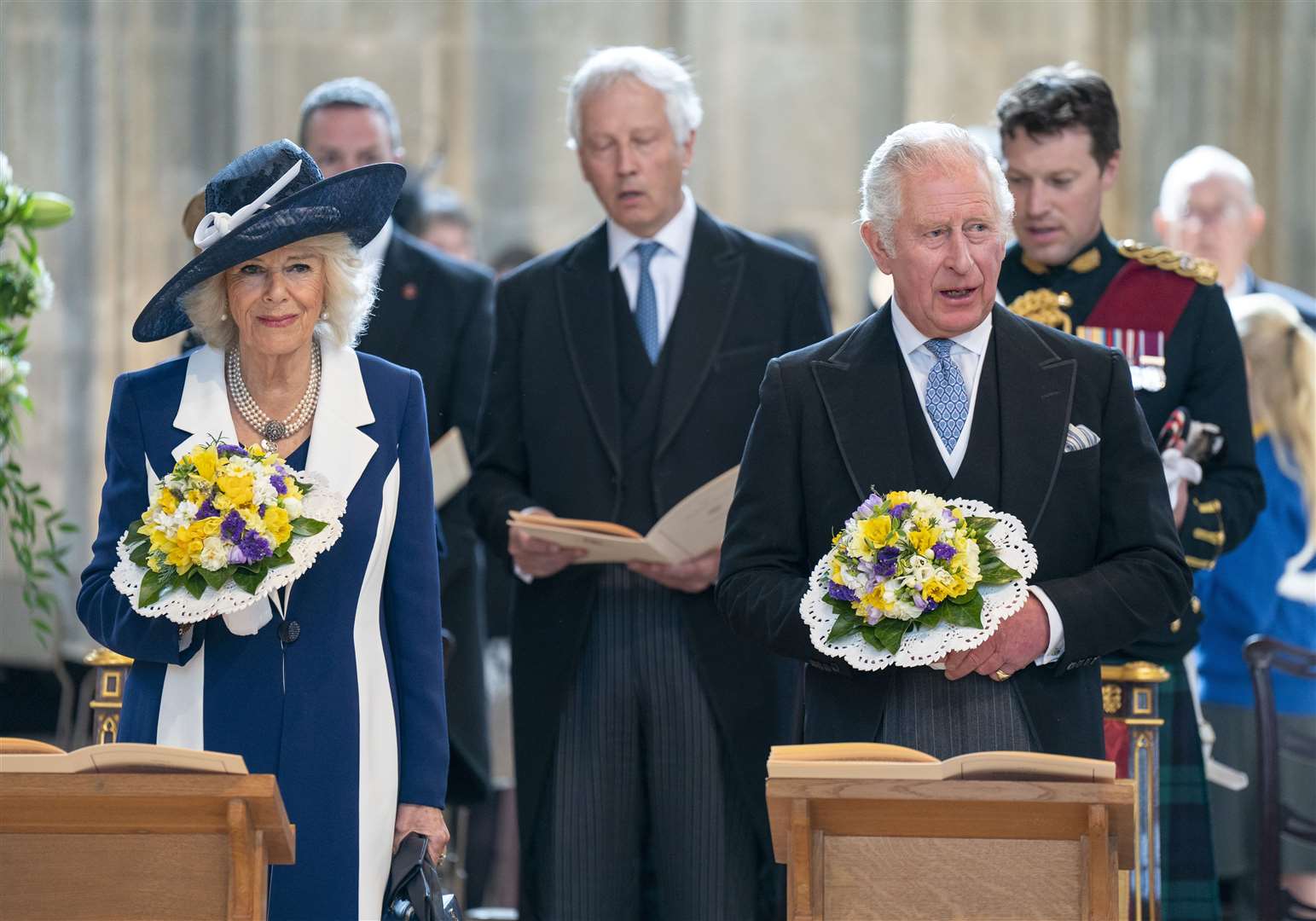 The Prince of Wales and Duchess of Cornwall were presented with nosegays when they first arrived at St George’s Chapel (Arthur Edwards/The Sun/PA)