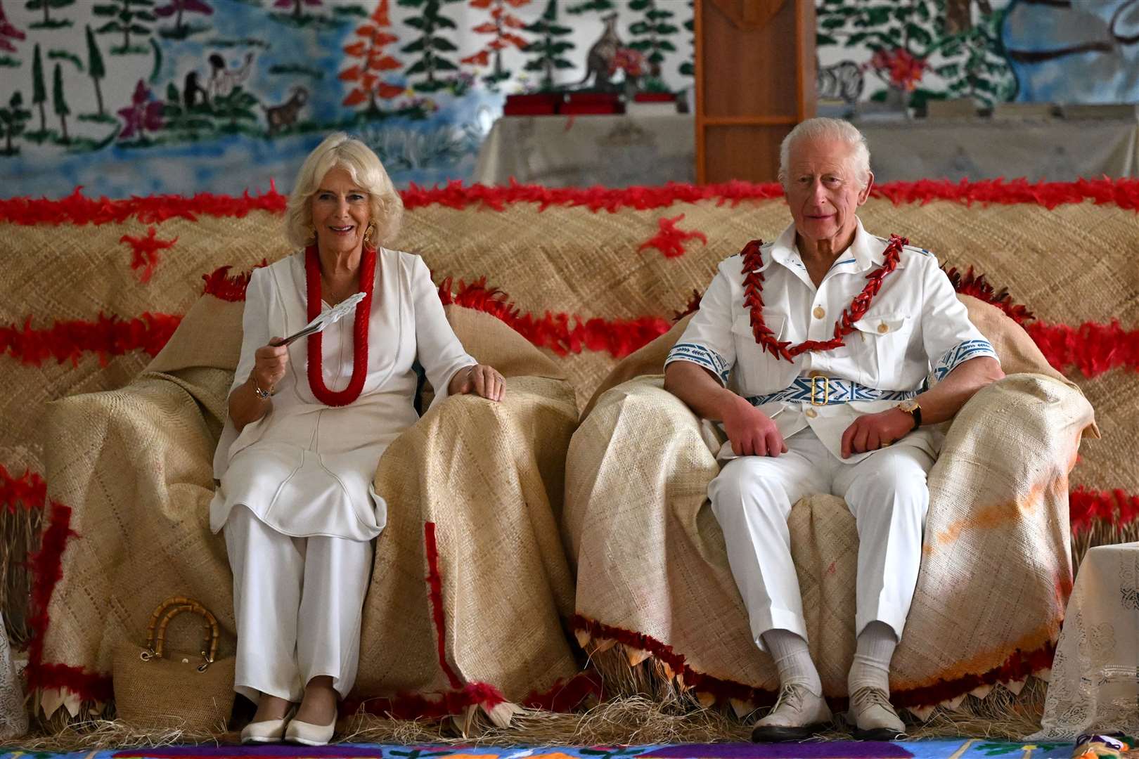 The King and Queen during a traditional ceremonial welcome during a visit to Moata’a Church Hall in Samoa (Victoria Jones/PA)