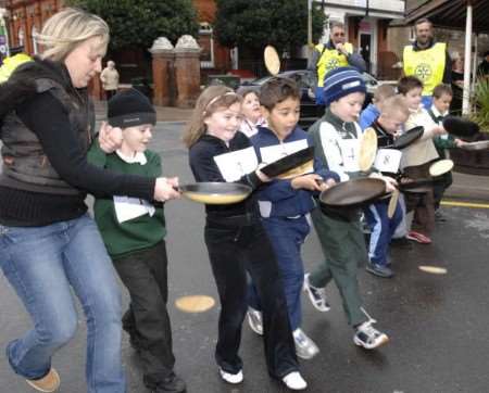 FLIPPING GOOD FUN: Youngsters try to keep a steady hand in one of Angelo's pancake races. Pictures: GERRY WHITTAKER