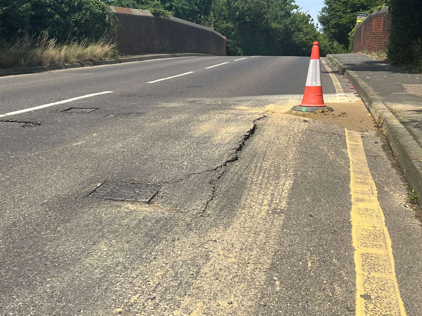 A water leak is causing the Maidstone Road (B2160) to crumble where it goes over the railway line in Paddock Wood. Picture: UKNIP