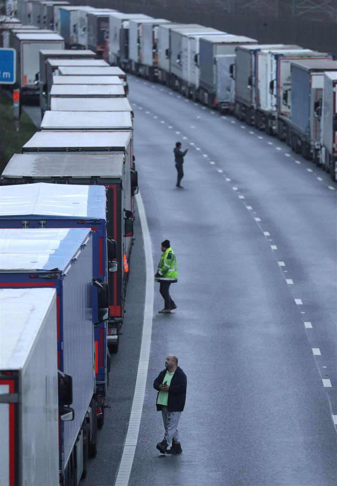 Lorry drivers walk about on the M20 in Kent where freight traffic is parked up near to Folkestone services whilst the Port of Dover remains closed. (Andrew Matthews/PA)