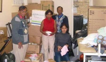 Family members packing just some of the hundreds of items donated by Thanet people. Picture: KARINA HODDER