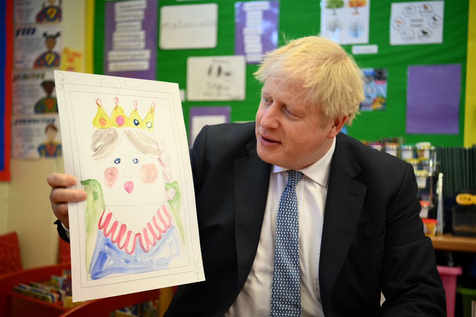 Boris Johnson with the portrait he painted of the Queen during a visit to Field End Infant school, in South Ruislip (Daniel Leal/PA)