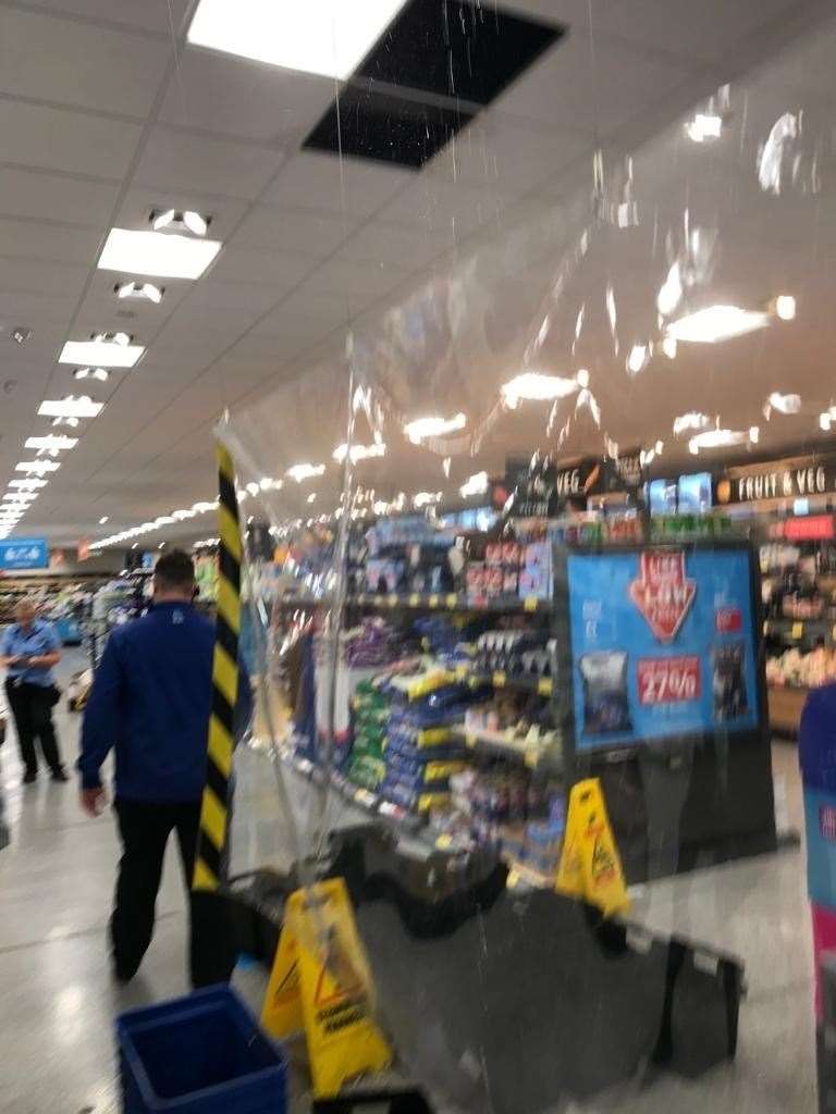 Shoppers were evacuated from the store as rain leaked through the roof causing ceiling tiles to fall
