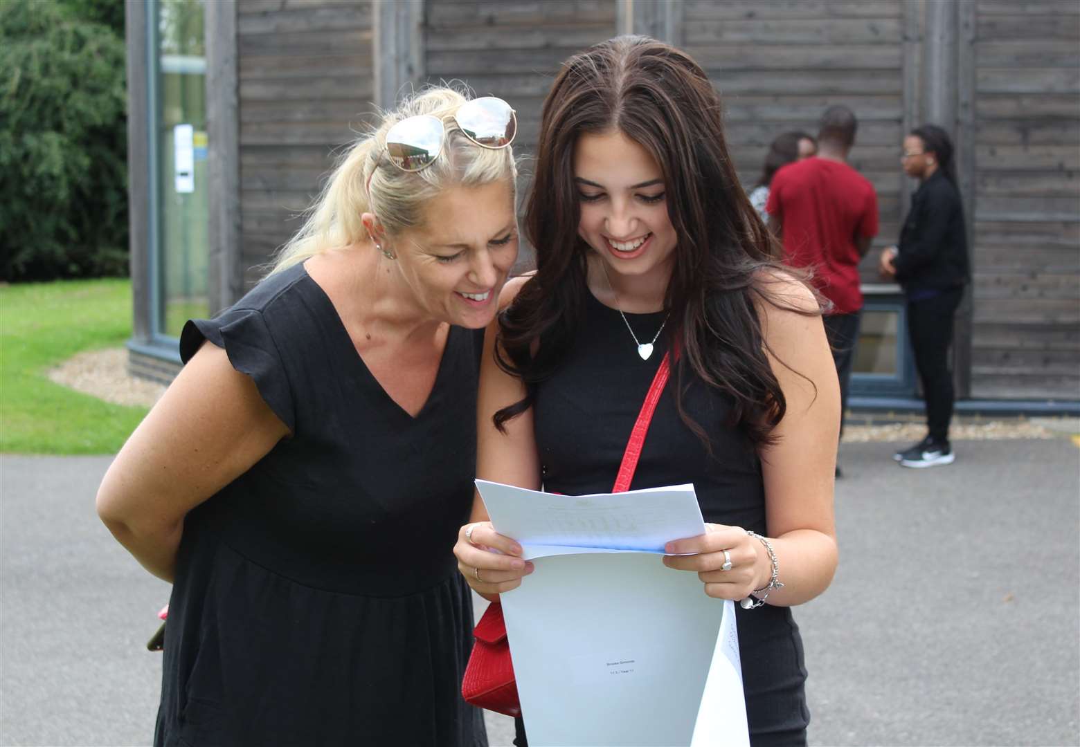 Brooke Simonds, 16, checking her GCSE results at Sittingbourne's Highsted Grammar School for Girls as her mum Allison looks on