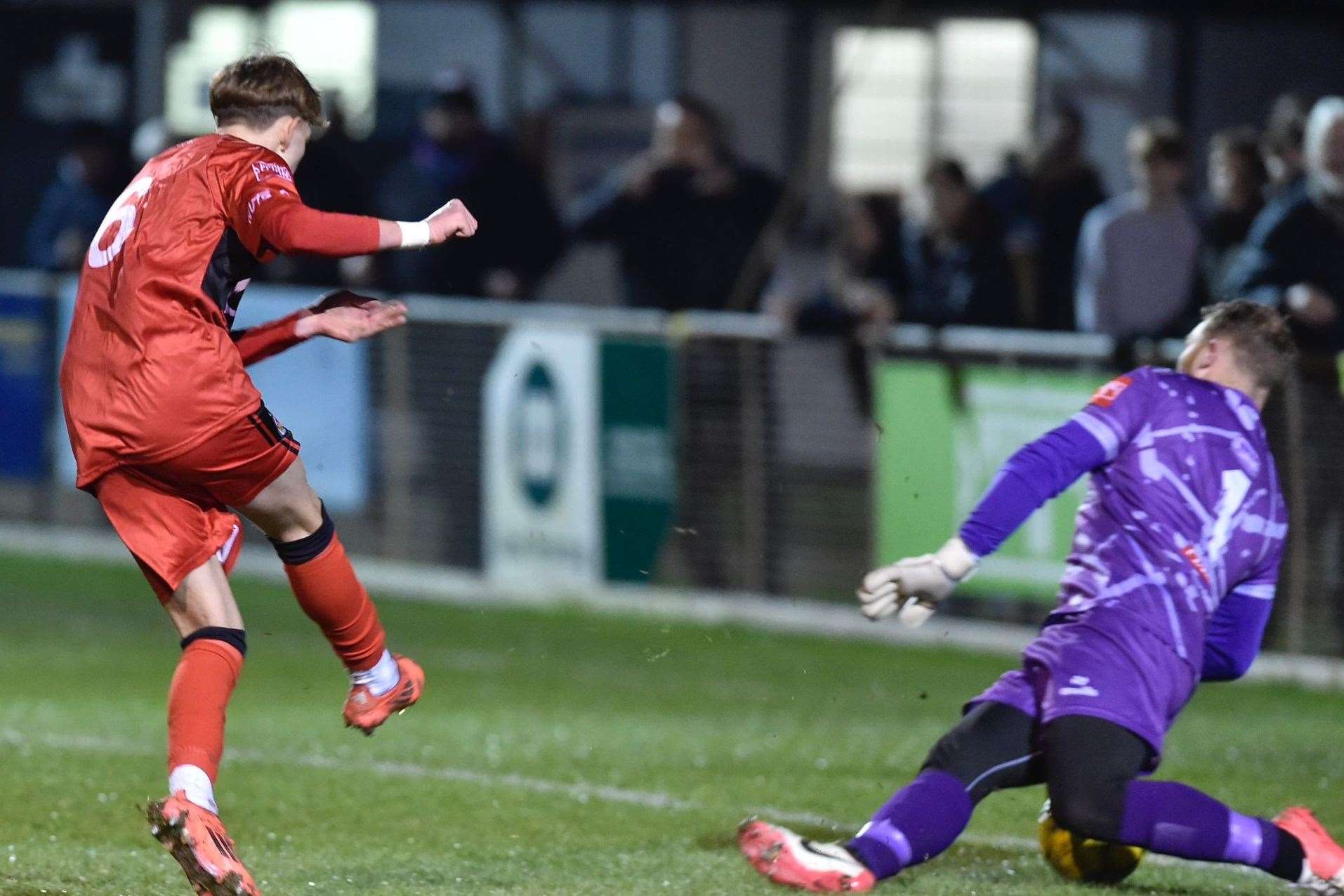 Preston Kedwell fires Ashford in front at Deal with his first goal in senior football as he slots underneath Deal goalkeeper Adam Molloy in the Hoops’ 3-1 home loss last Tuesday. Picture: Ian Scammell