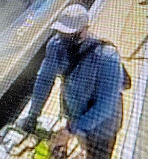 A man wearing a mask and pushing a bike at a train station is wanted by police. Picture: Kent Police