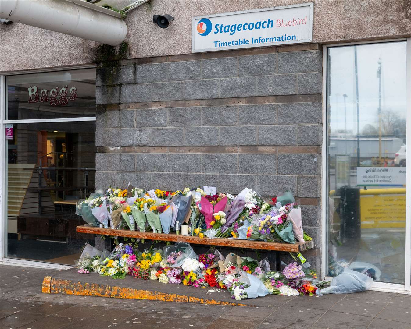 Floral tributes were left at the bus station after the death of driver Keith Rollinson (Alamy/PA)