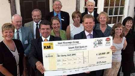 STEP FORWARD: David Lewis, chief executive of the KM Group, and Jonathan Neame, Shepherd Neame's managing director, with representatives of the nine hospices to benefit